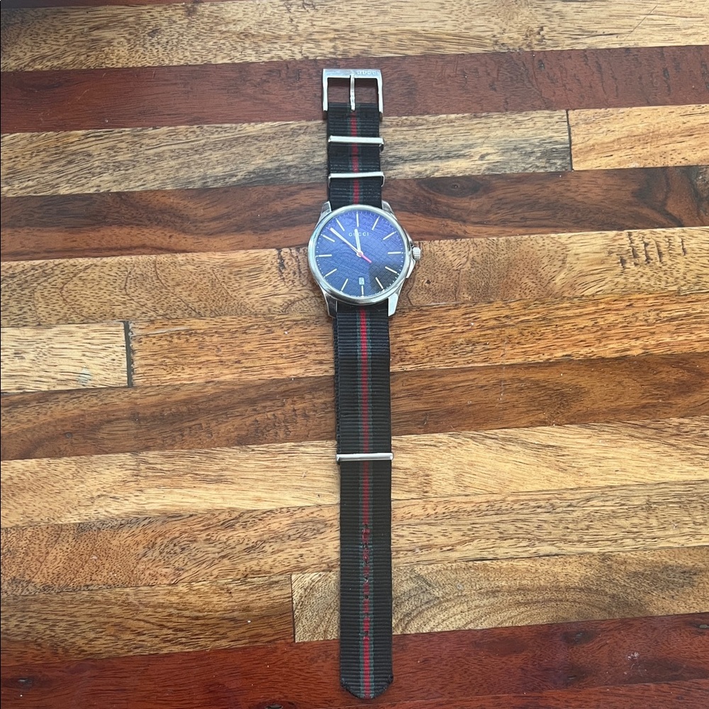 Gucci authentic G-Timeless men’s watch with signature green/red NATO strap